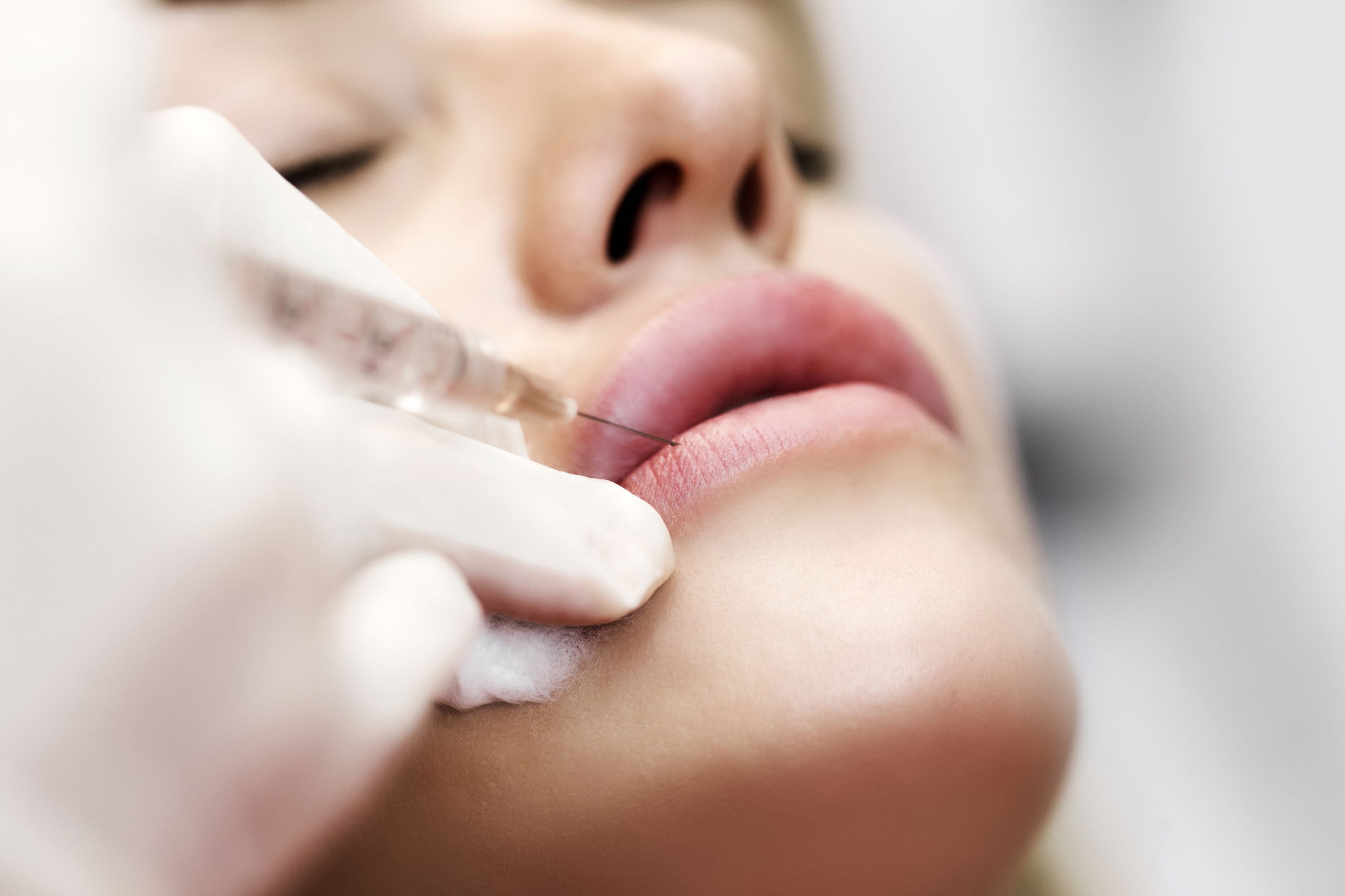 Professional cosmetologist injecting silicone in lips - Botox