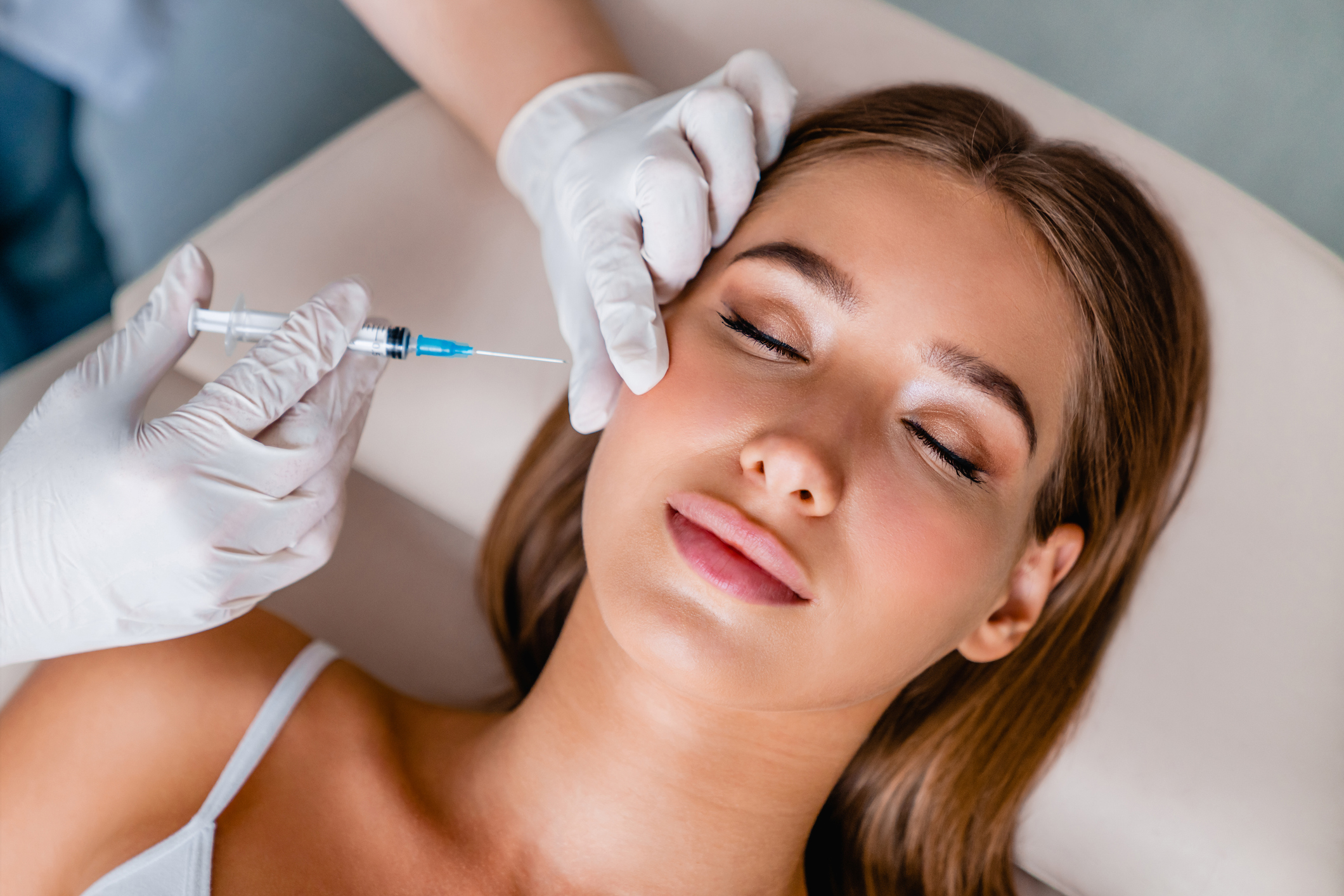 Young woman gets beauty facial injections in salon - Botox